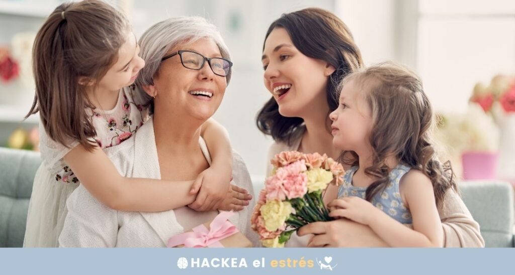 imagen de abuela, madre y dos niñas intercambiando abrazos y flores